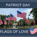Several American flags on poles surround a memorial plaque in a park. The text reads Patriot Day Flags of Love with a heart-shaped American flag at the bottom right.